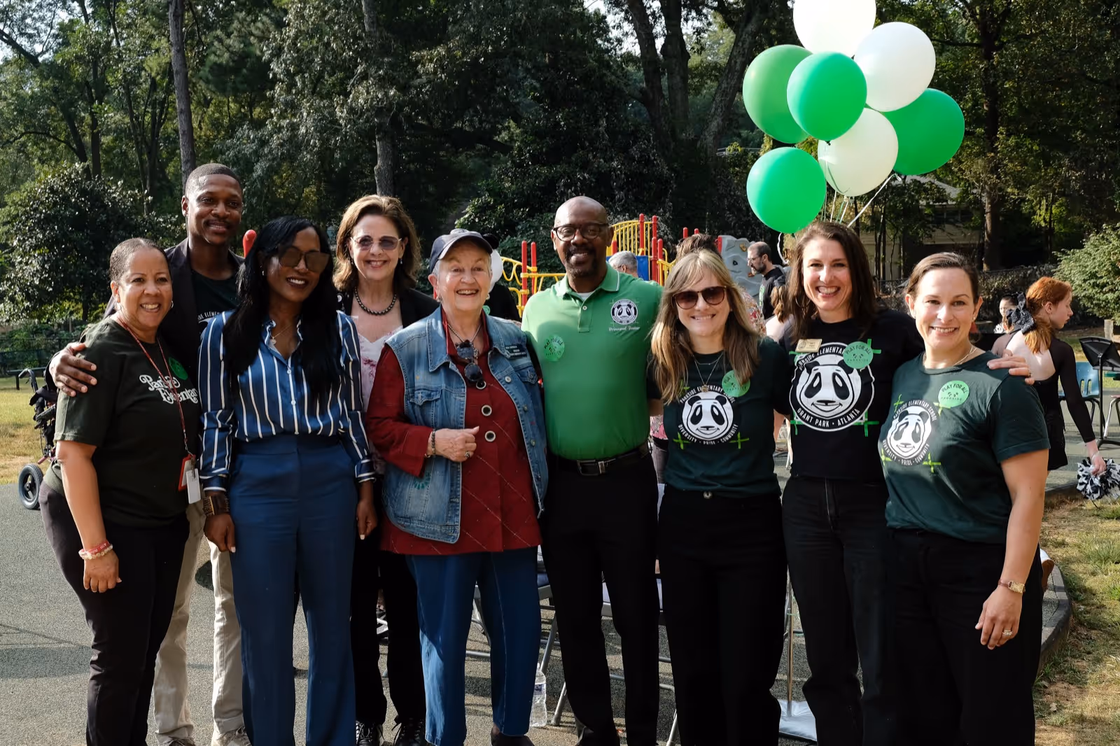 A photo of the Parkside Foundation Board of Directors posing outside the school on the day of the playground ribbon cutting.
